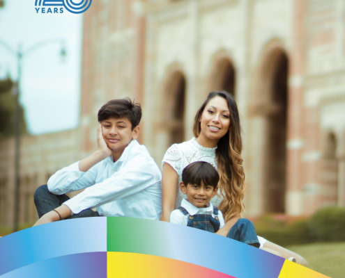 Yazmin Gonzalez, UCLA Latin American Studies class of 2016 and M.A. class of 2017, sits outdoors with two children near a campus building.