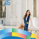 Ariana Reyes-Ramirez, UCLA Ethnic Studies and Education class of 2021, poses in a graduation stole outside a campus building.