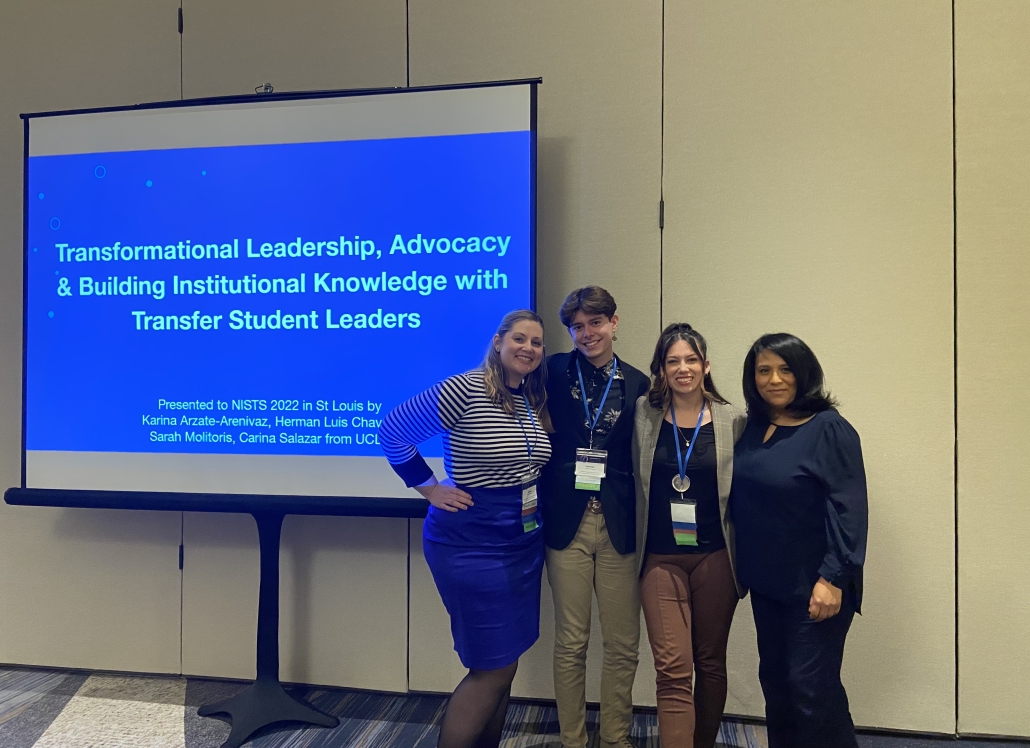 Carina Salazar and three fellow presenters pose beside a projected presentation titled “Transformational Leadership, Advocacy & Building Institutional Knowledge with Transfer Student Leaders” at the NISTS 2022 conference in St. Louis.