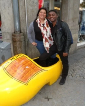 Aranzazu and another person pose inside an oversized yellow wooden shoe.